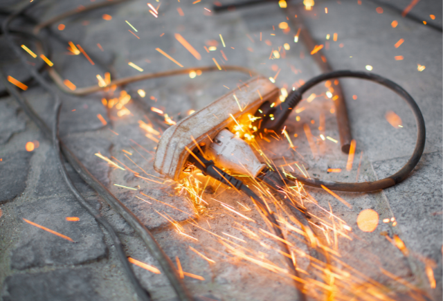 Burning electrical outlet and sparks illustrating electrical hazards and emergency services.