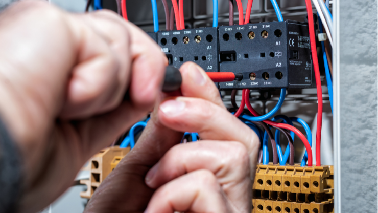 Electrician working on electrical panel, upgrading home electrical system in Snohomish County.